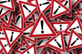 Photo of triangular signs with exclamation points